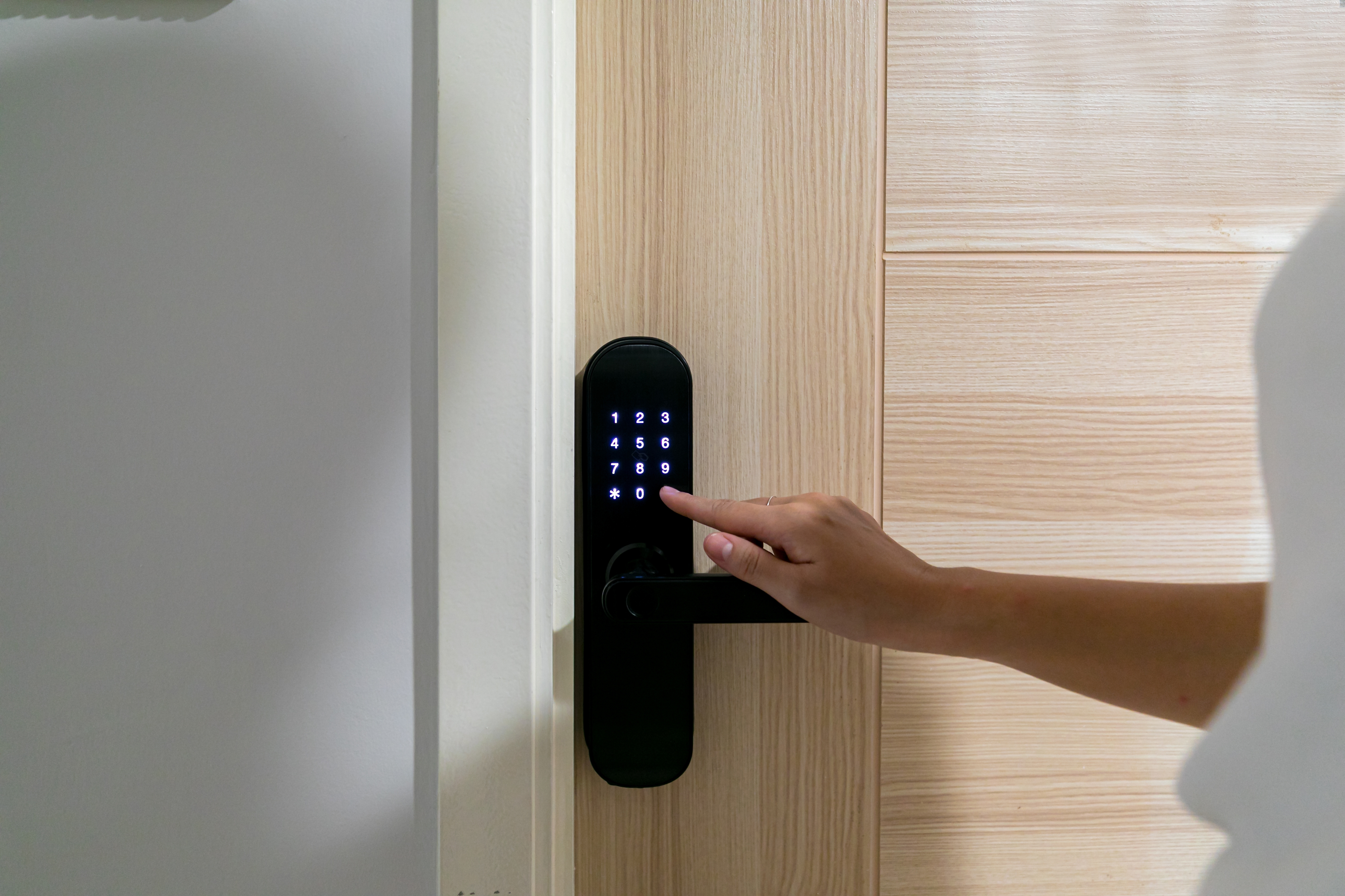 Hand,Open,Door,Digital,And,Access,Control,In,A,Condo shutterstock 2227602137