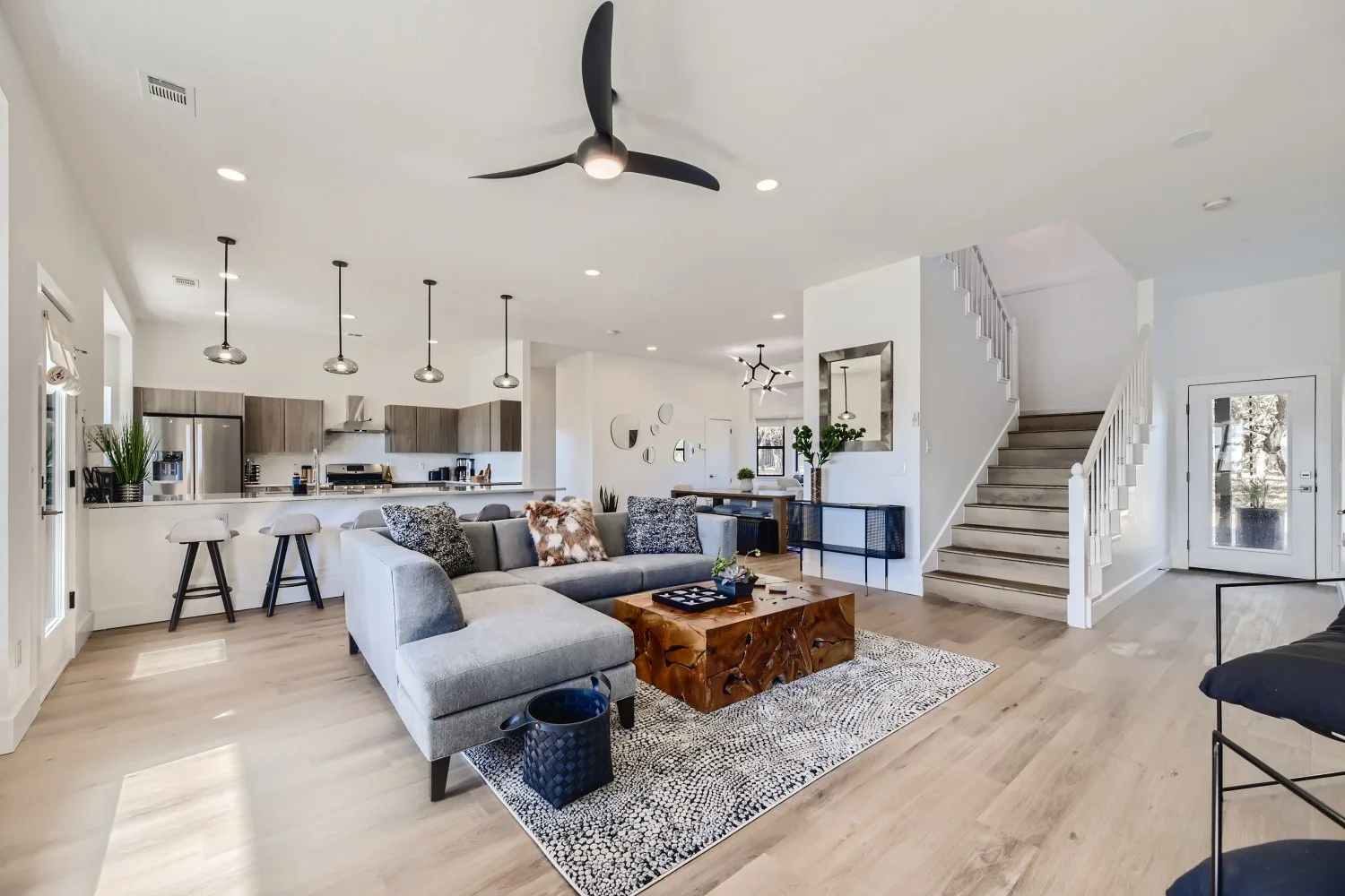 Mastering Airbnb Hosting: 15 Essential Tips for Success 4 Living room in Airbnb with open floor plan kitchen behind.