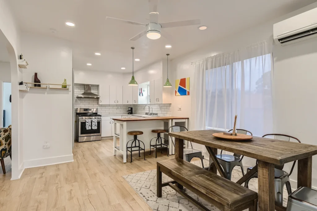 How to Start an Airbnb Business: A Step-by-Step Guide 3 Kitchen of an Airbnb in Austin with wood dining table.
