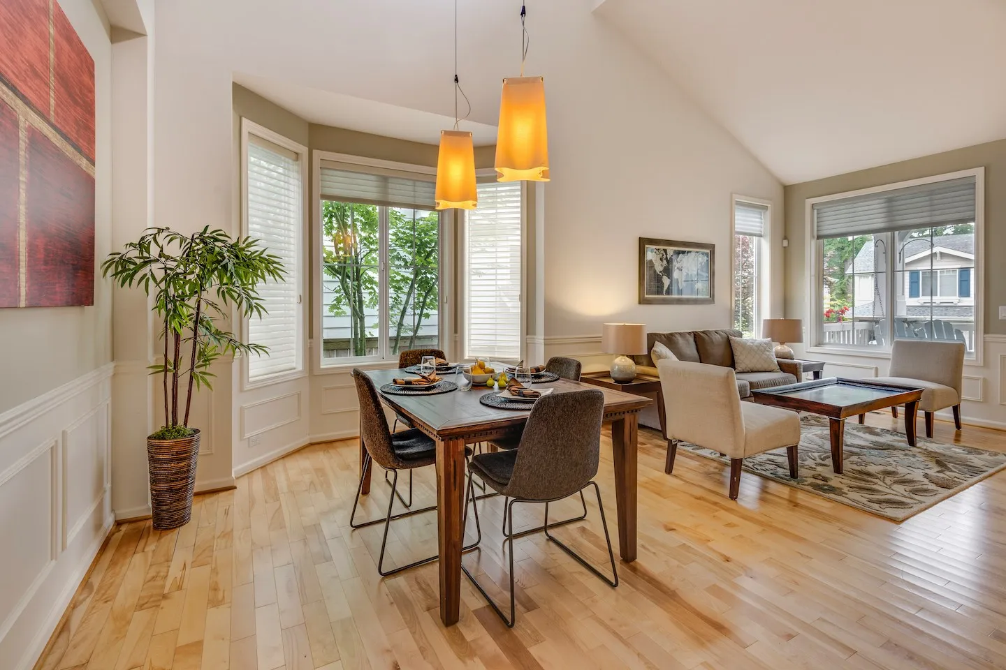 Secure Your Stay: A Guide to Avoiding Airbnb Scams 1 An open space, beige living room with a wooden table and couch in the background.
